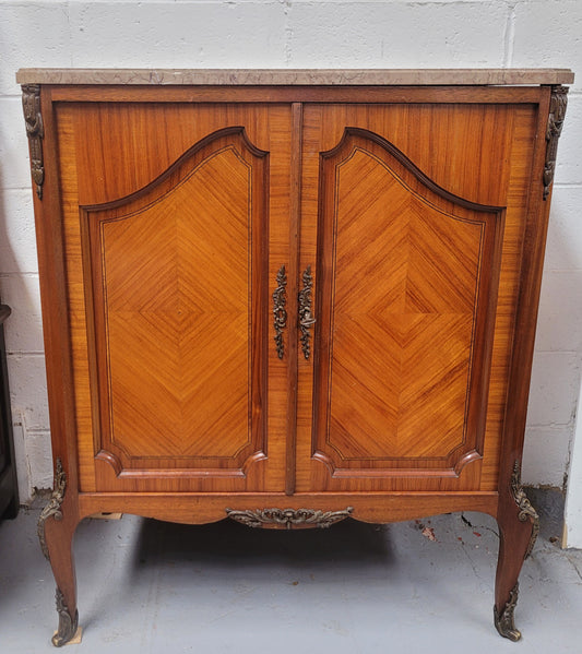 Stunning compact Louis 15th style two door walnut cabinet with ormolu trim and marble top. It is in good original condition.