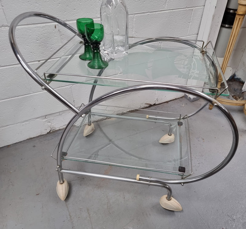 Stylish Art Deco chrome & frosted glass drinks trolley. Bakelite guards on the wheels. It is in good original condition and has been sourced locally.