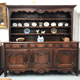 Grand 19th century Oak French kitchen dresser. A beautiful very practical piece with loads of storage havings three large shelves, three large drawers and three shelves for displaying items. It has been sympathetically restored and is in good detailed condition.