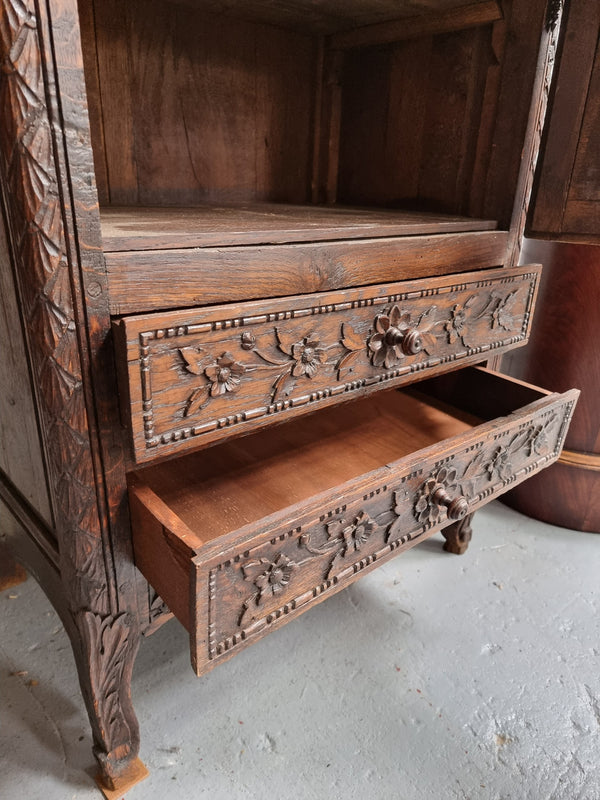 Petite oak armoire display cabinet with a glass door, two drawers at the bottom and three shelves inside. Late 18th Century and amazing detailed decorative carvings. Sourced from France and in good original condition.