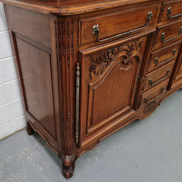 Beautiful 19th century Walnut Louis XV style sideboard with plenty of storage space. The top has two doors that open up to three adjustable shelves. It is in good original detailed condition.