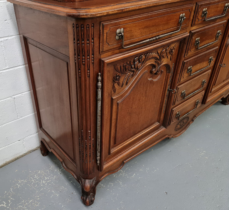 Beautiful 19th century Walnut Louis XV style sideboard with plenty of storage space. The top has two doors that open up to three adjustable shelves. It is in good original detailed condition.