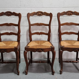 Lovely set of six French oak rush seated provincial dining chairs. They have been sourced from France and are in good detailed condition.