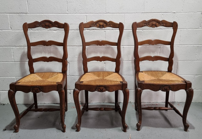 Lovely set of six French oak rush seated provincial dining chairs. They have been sourced from France and are in good detailed condition.