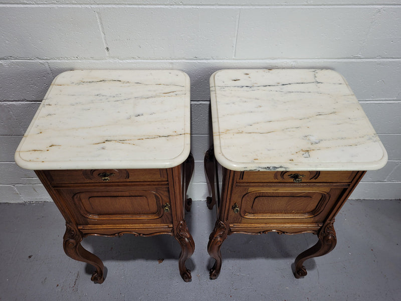 Pair of Louis XV style bedside cabinets with beautiful marble tops and one drawer and single cupboard for all your storage needs. In good original detailed condition.