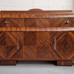 Vintage Walnut Art Deco “Waterfall” sideboard buffet with two drawers and two doors. It is in good original condition and has been sourced locally.