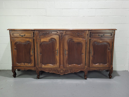 Walnut Louis XV style parquetry top four door sideboard with beautiful carving. Plenty of storage space and it is in good original detailed condition.