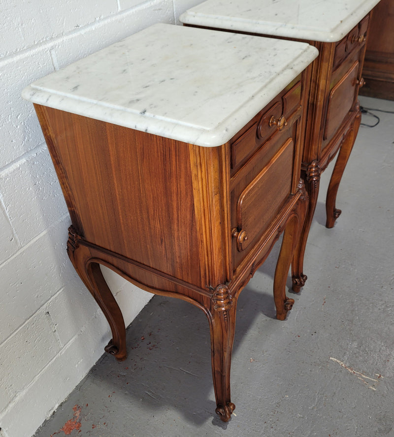 Pair of stunning Louis XV style French Walnut white marble top bedside cabinets. They have one drawer and a cupboard that is marble lined. The marble has been polished and they are in good original detailed condition.