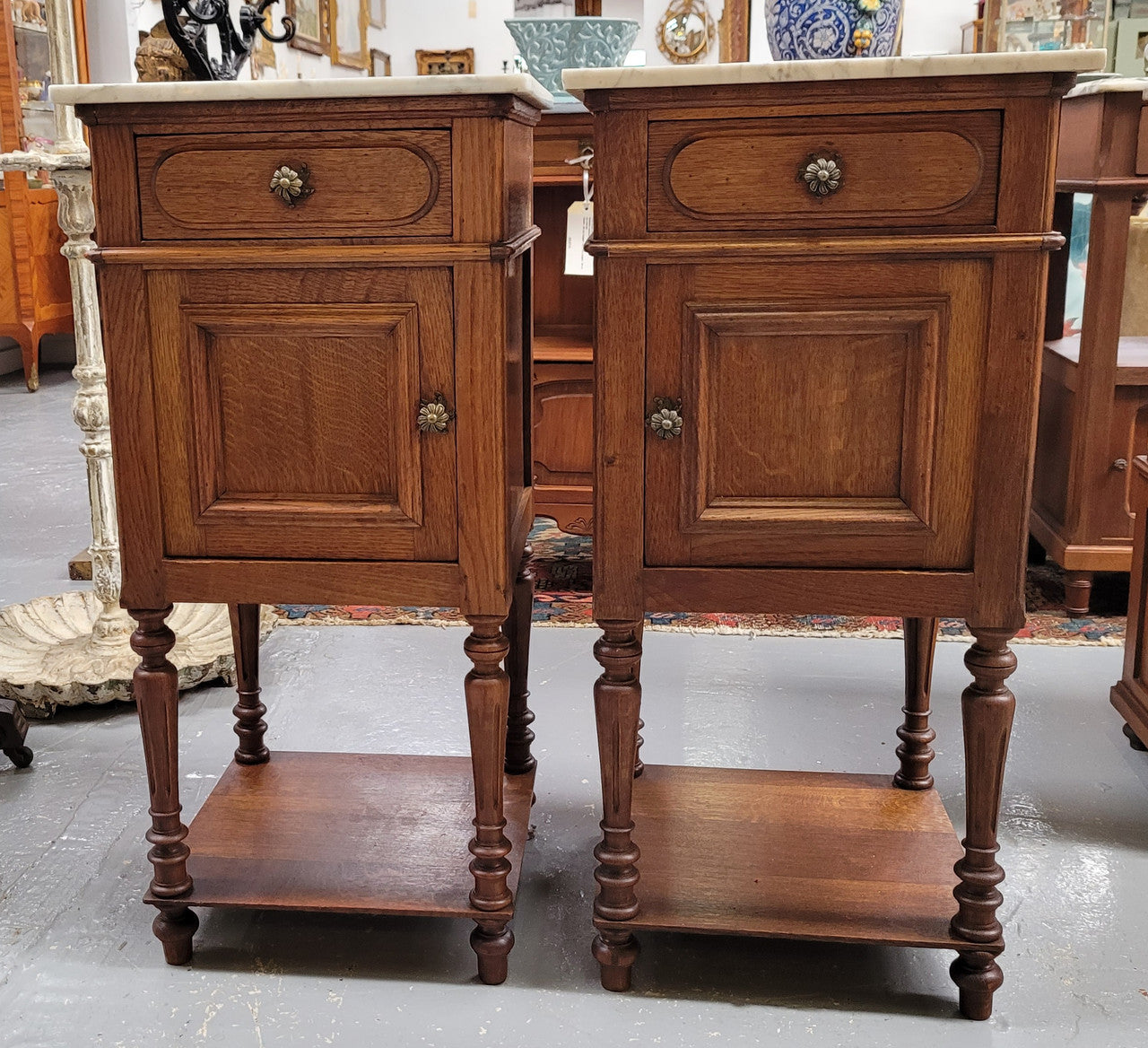 Antique French Oak Henry II white marble top bedside cabinets. They have one drawer and cupboard a long with an open shelf at the bottom. Sourced from France and in good original detailed condition.