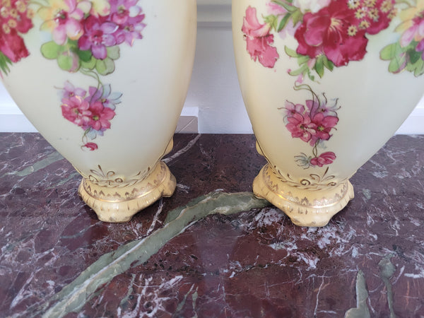 A beautiful pair of Edwardian Austrian hand-painted vases depicting a decorative flower scene. They are in good original condition with no chips or cracks. Please view photos as they help form part of the description.