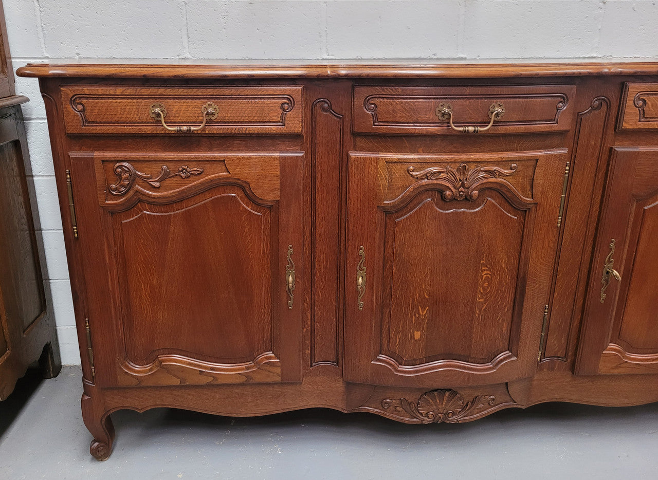 French Oak Louis XV style three drawer three door parquetry top sideboard. It has been sourced from France and is in good original detailed condition.