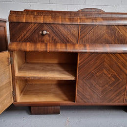 Vintage Walnut Art Deco “Waterfall” sideboard buffet with two drawers and two doors. It is in good original condition and has been sourced locally.