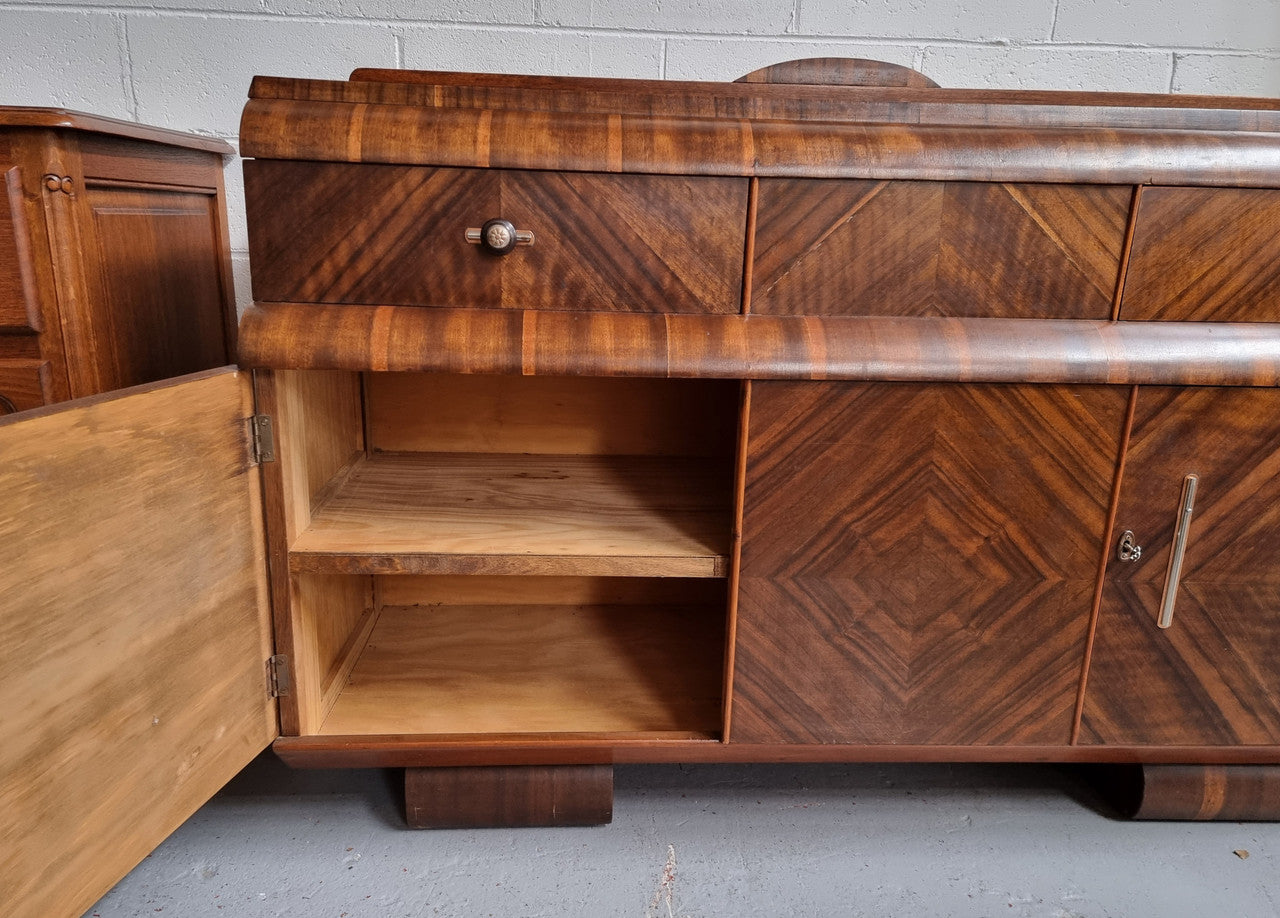 Vintage Walnut Art Deco “Waterfall” sideboard buffet with two drawers and two doors. It is in good original condition and has been sourced locally.