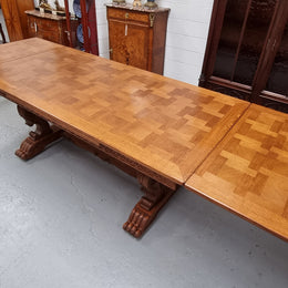 Amazing French Oak Renaissance style parquetry top extension table. Beautiful parquetry top and amazing detailed carvings on the legs. It extends to 306 cm long when fully extended. Sourced from France and in good original detailed condition.