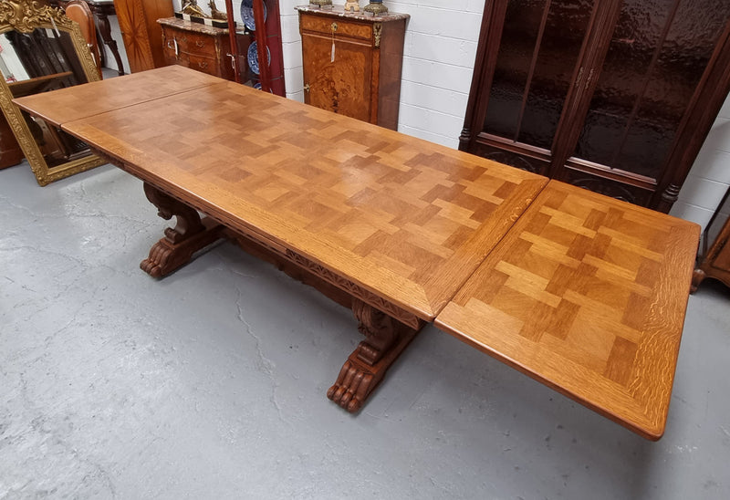 Amazing French Oak Renaissance style parquetry top extension table. Beautiful parquetry top and amazing detailed carvings on the legs. It extends to 306 cm long when fully extended. Sourced from France and in good original detailed condition.