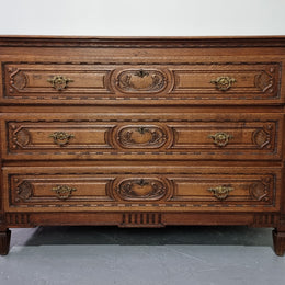 Early 19th Century French Oak chest of three drawers. It has beautiful handles and carvings. It is in good original detailed condition.
