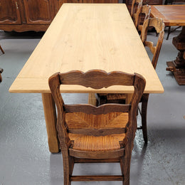 French raw Oak stretcher based refectory table. Features raw wood that could be used as is for a distressed look, or finished and waxed for a more refined look. Sourced from France and in good original condition.
