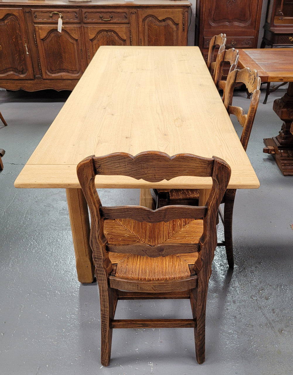 French raw Oak stretcher based refectory table. Features raw wood that could be used as is for a distressed look, or finished and waxed for a more refined look. Sourced from France and in good original condition.