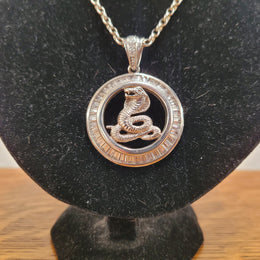 Sterling Silver pendant featuring a Cobra Snake with Cubic Zirconia surround. Heavy Bale with Cubic Zirconia. Pendant without Bale, 3.5cm Diameter. Includes 60 cm Sterling Silver Chain.