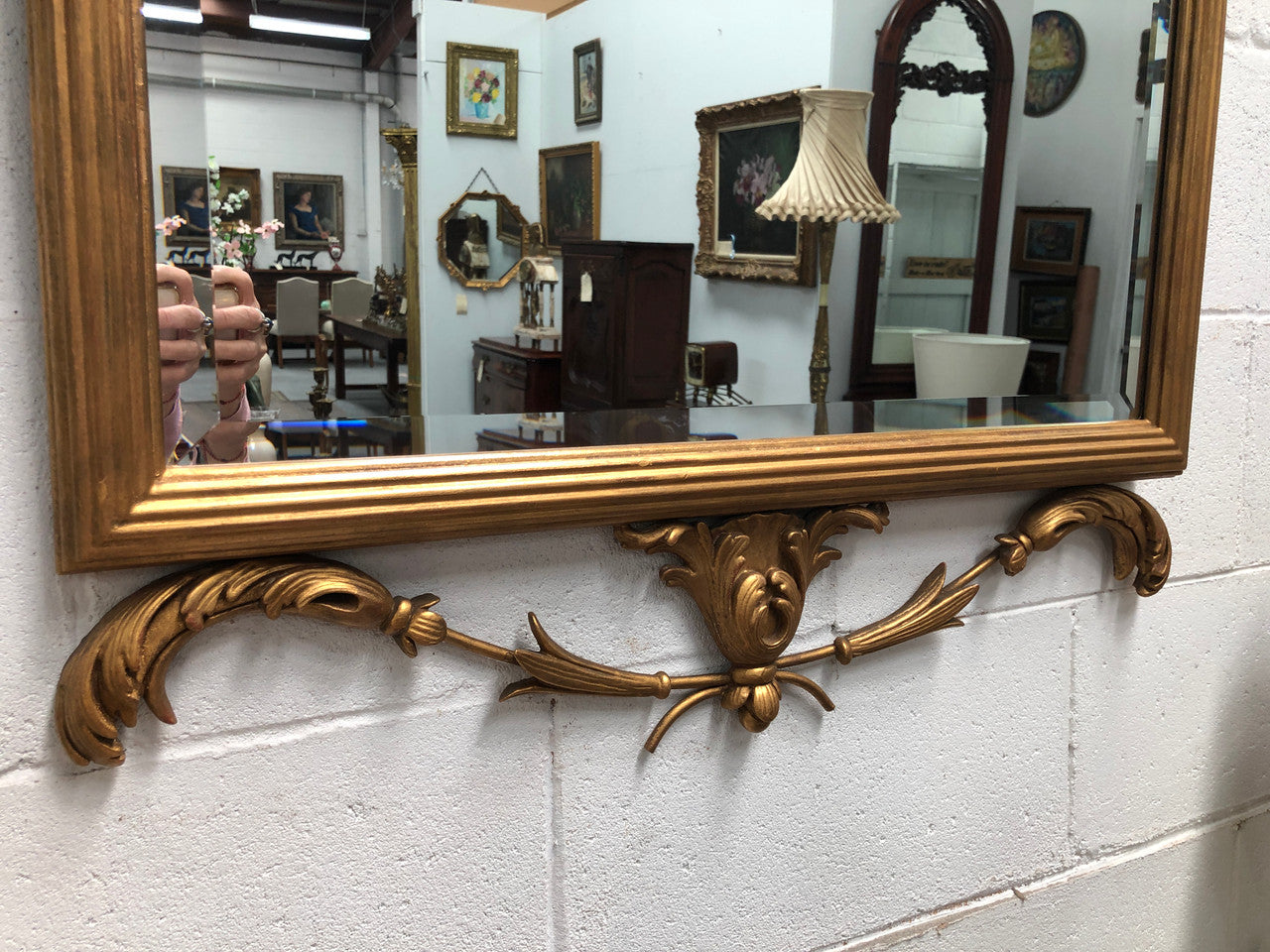 Mid 20th Century Italian gilt wood framed gold wall mirror. Highly decorative carving with a bevelled mirror. Is in good original condition.