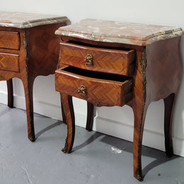 Pair of Louis XV commode style two drawer bedsides with beautiful marble tops and decorative mounts. They are a rare size and are in good, detailed condition.
