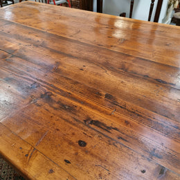 Reclaimed Pine and Oregon stretcher base dining table. The top has an amazing patina and character. Can very comfortable seat 12 and is in good original detailed condition .