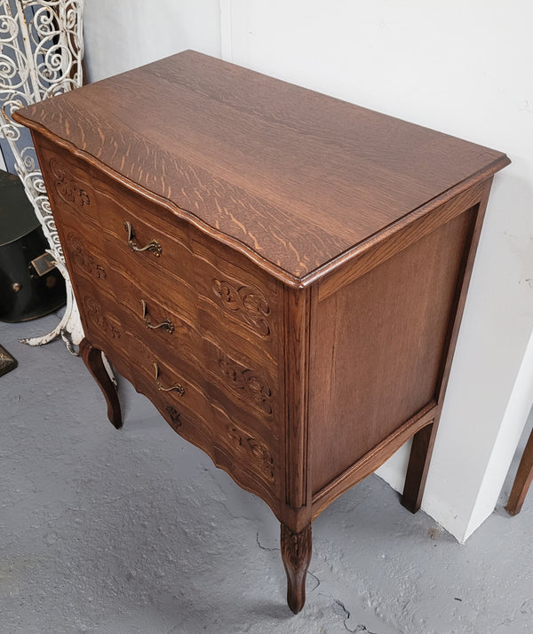 French Oak Louis XV style three drawer commode. It has been sourced from France and has decorative handles and carvings. It is in good original detailed condition.