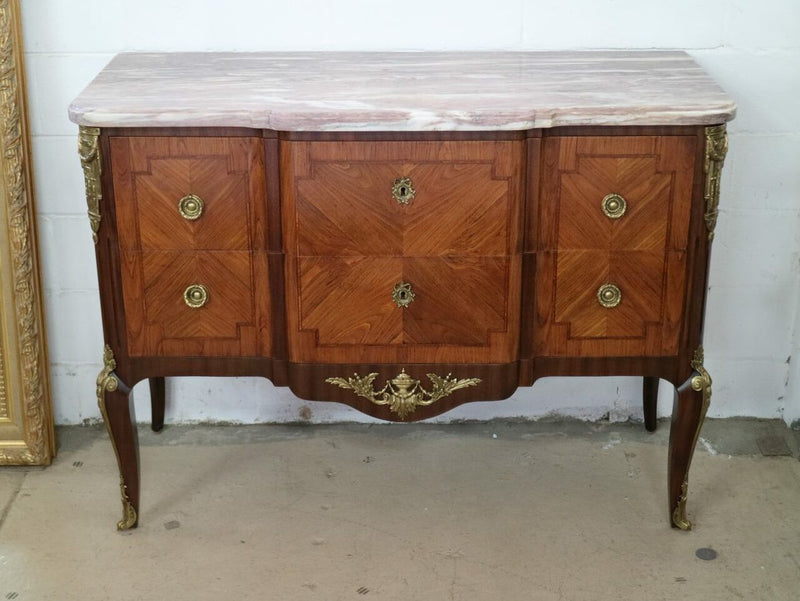 A stunning French transitional Louis XV and Louis XVI style commode. It has beautiful walnut inlay and a fabulous marble top. Comes with two drawers and fitted with gilt brass mounts. it is In very good original condition.