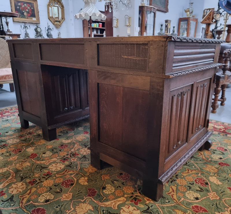 Beautifully carved French Oak early 19th century pedestal desk with 3 drawers, two cupboards and a secret cupboard on the side. There is also a lovely burgundy tooled leather top. In good original detailed condition.