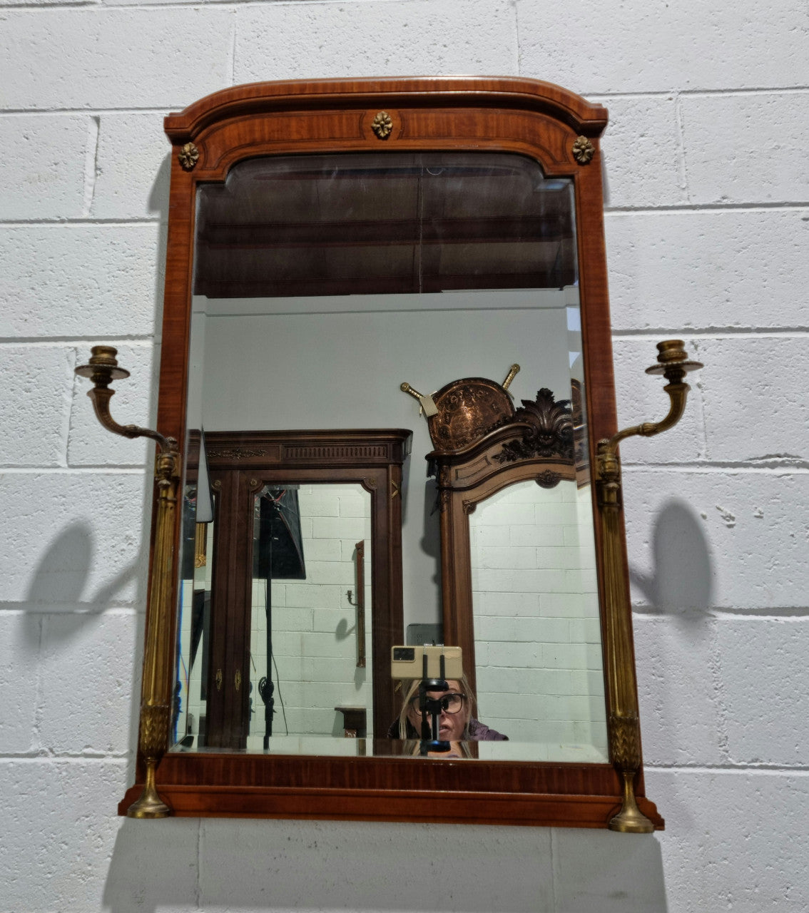 Decorative late 19th Century mahogany French wall mirror with brass swivel candle holders and brass detail. In good original detailed condition.