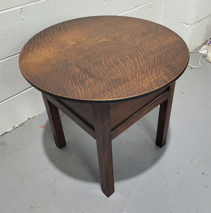 Fabulous round oak side table which also has a hidden sewing box underneath with lovely original blue satin lining and Includes pictured sewing items. It is in good original condition.