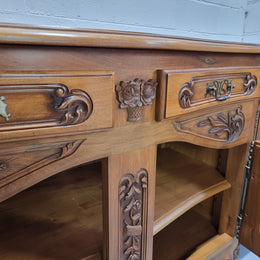 Amazing grand Walnut four door beautifully carved Louis XV style sideboard. Plenty of storage space with four doors all with adjustable shelves and two drawers. In good original detailed condition.