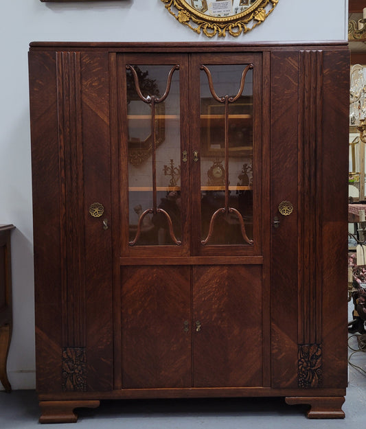 Stylish French Art Deco Oak bookcase with heaps of storage space and shelves. Middle section has two glass display doors. In good original detailed condition.