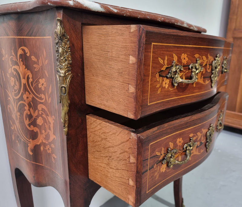 A stunning French petite two drawer inlaid Rosewood commode. In good original detailed condition.