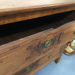 Lovely carved early 19th Century French Oak commode. There are three drawers with decorative drawer pulls and is in good original detailed condition.