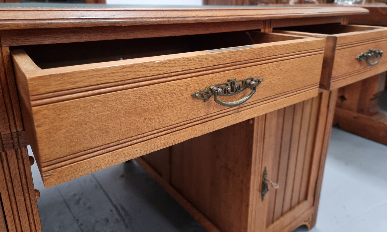 French Oak Art Deco full partners desk with leather top. Plenty of storage with both sides having three drawers at the top and two cupboards on both sides, one side has a filing section with three internal drawers and the other has a shelf on one side with three internal drawers as well. In good original detailed condition.