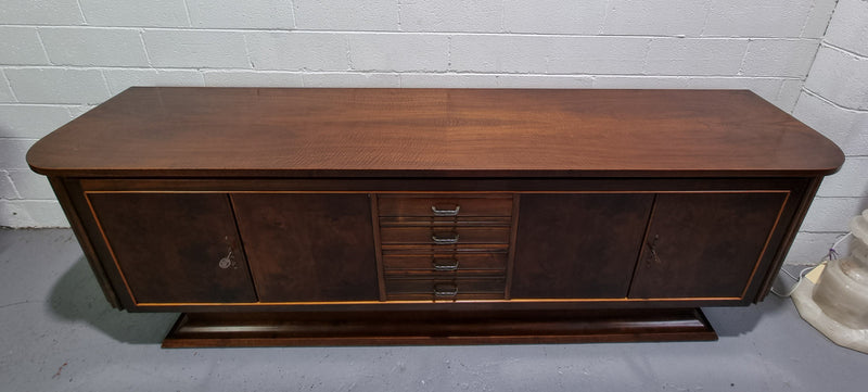 Amazing French Walnut Art deco four door buffet. The doors either side open to a fixed shelf and plenty of added storage with four drawers. In good original detailed condition.