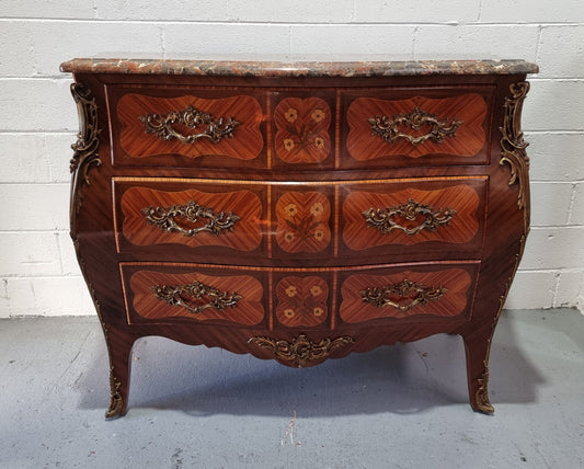 French Walnut and Kingwood Louis XV style marquetry inlaid commode with three drawers and a beautiful marble top. It is in good original detailed condition.