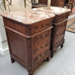 A pair of hard to find French Oak Louis XV style four drawer marble topped bedsides with attractive carvings. They are in good original detailed condition and have been sourced from France.