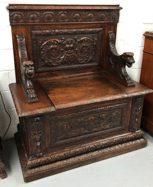Beautifully carved 19th century gothic style hall seat. The seat lifts up for storage underneath and in very good condition.