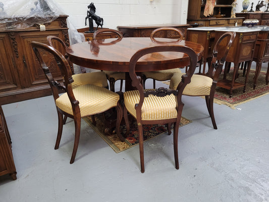 William IV Rosewood tilt top round table with six Rosewood chairs. It has been sourced from locally and is in good original detailed condition.