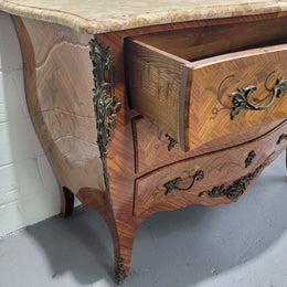 French three drawer marquetry inlaid marble top commode with decorative ormolu mounts. In good original detailed condition.