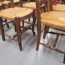 Set of six Louis XV style French Oak rush seat dining chairs. They are in good original detailed condition.