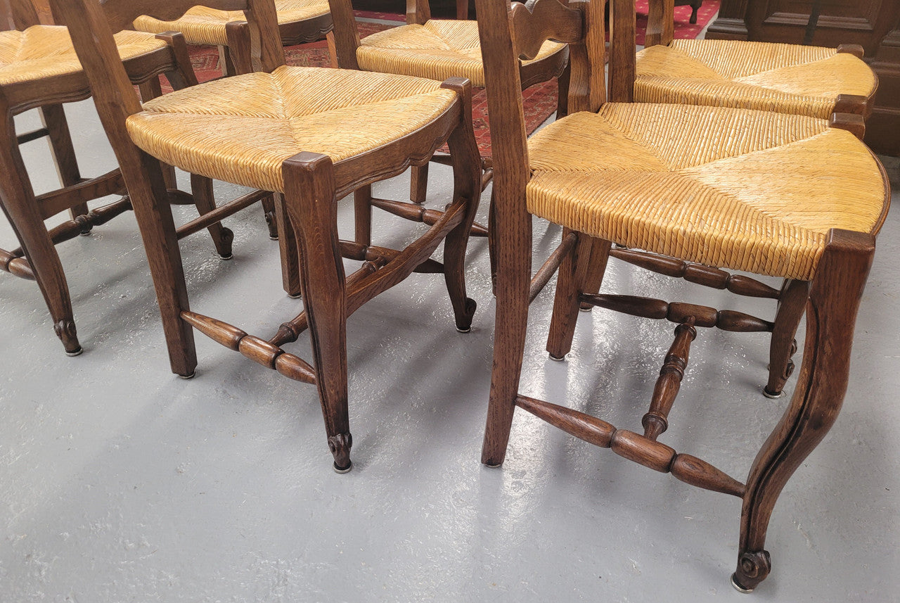 Set of six Louis XV style French Oak rush seat dining chairs. They are in good original detailed condition.