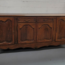 Louis XV style French Oak sideboard consisting of four doors and two drawers. It is in good restored condition.