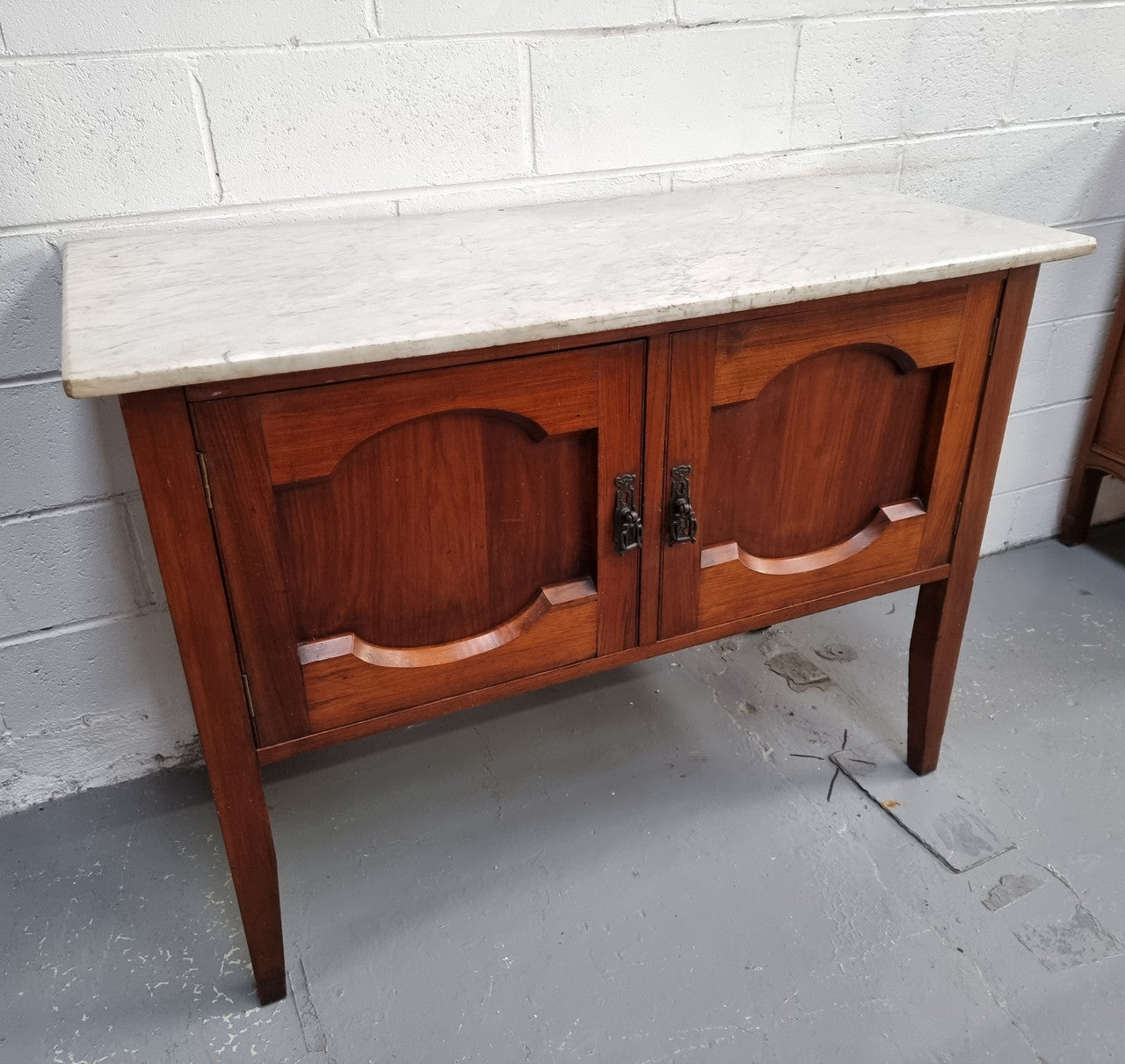 Blackwood two door white marble top cabinet. This would be ideal to be used as an entertainment unit, a TV stand or TV cabinet. In good original condition.