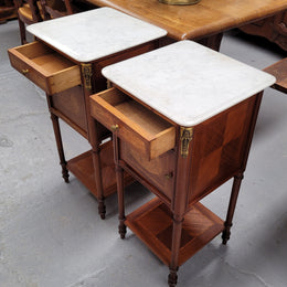 Pair of white marble topped Louis 16th style bedside cabinets consisting of one drawer and one cupboard.  Inlaid with burr walnut and has decorative mounts. They have been sourced from France and are in good original condition.