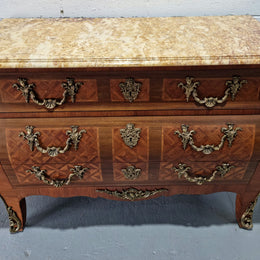 A beautifully inlaid parquetry three drawer commode with a lovely marble top, and decorative ormolu mounts. In good original detailed condition. Circa 1930