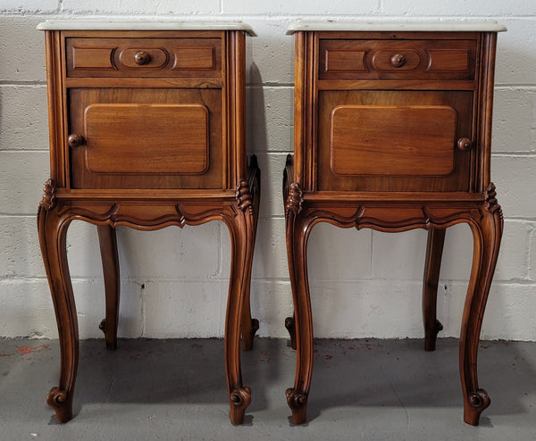 Pair of stunning Louis XV style French Walnut white marble top bedside cabinets. They have one drawer and a cupboard that is marble lined. The marble has been polished and they are in good original detailed condition.