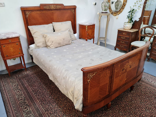 A high quality French Louis XV style bow fronted Queen size bed with marquetry inlay and ormolu mounts. In good original detailed condition. Circa: 1920